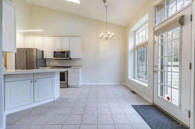 a large kitchen with cabinets and stainless steel appliances