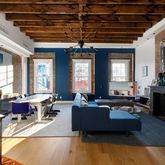 a living room with furniture or couch and a chandelier