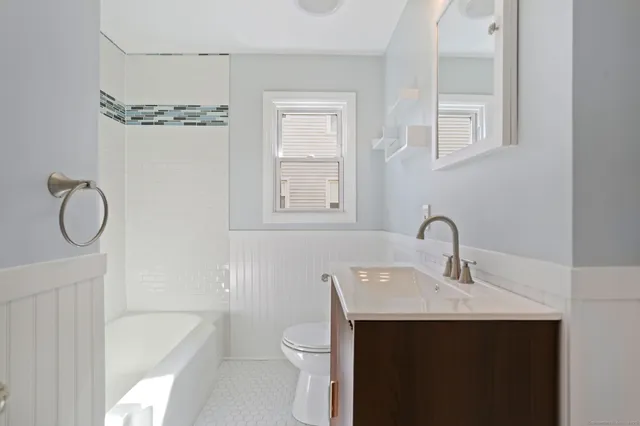 a bathroom with a sink toilet and shower