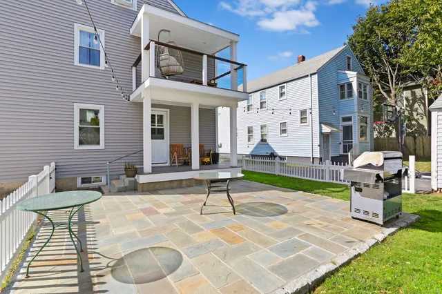 a view of a house with backyard porch and sitting area
