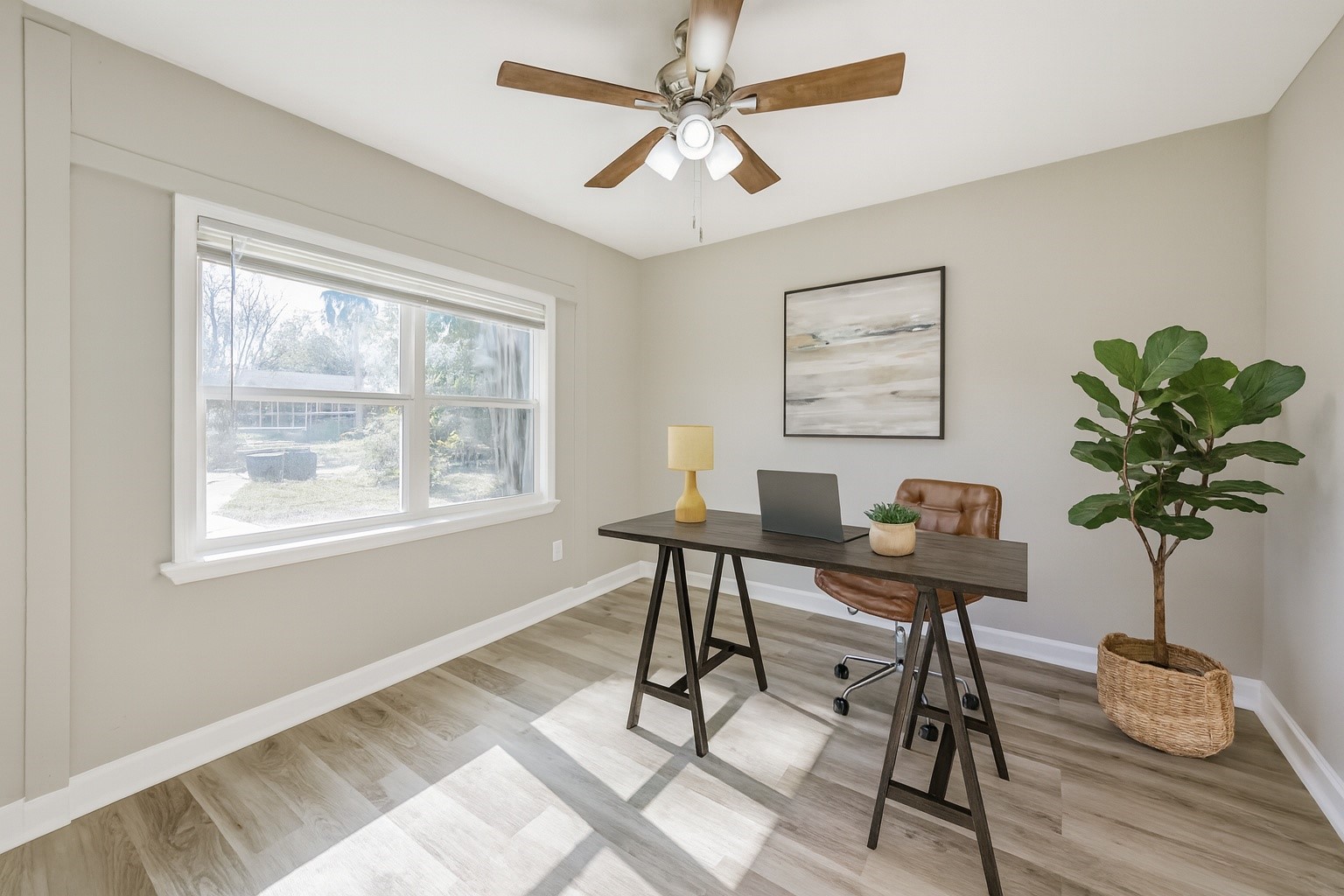 5130 Ripplebrook Drive Houston, TX 77045 - Photo 11 of 19 Secondary bedroom #1 has new vinyl plank flooring, fresh paint, new ceiling fan/light fixture, large window with window blinds and closet! Note: This photo has been virtually staged.