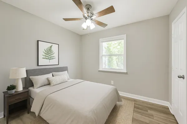 a bedroom with a large bed and a window