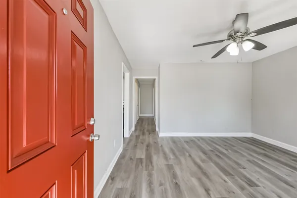 a view of a hallway with wooden floor and closet