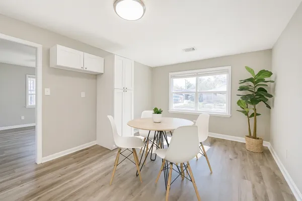 a view of a dining room with furniture window and wooden floor