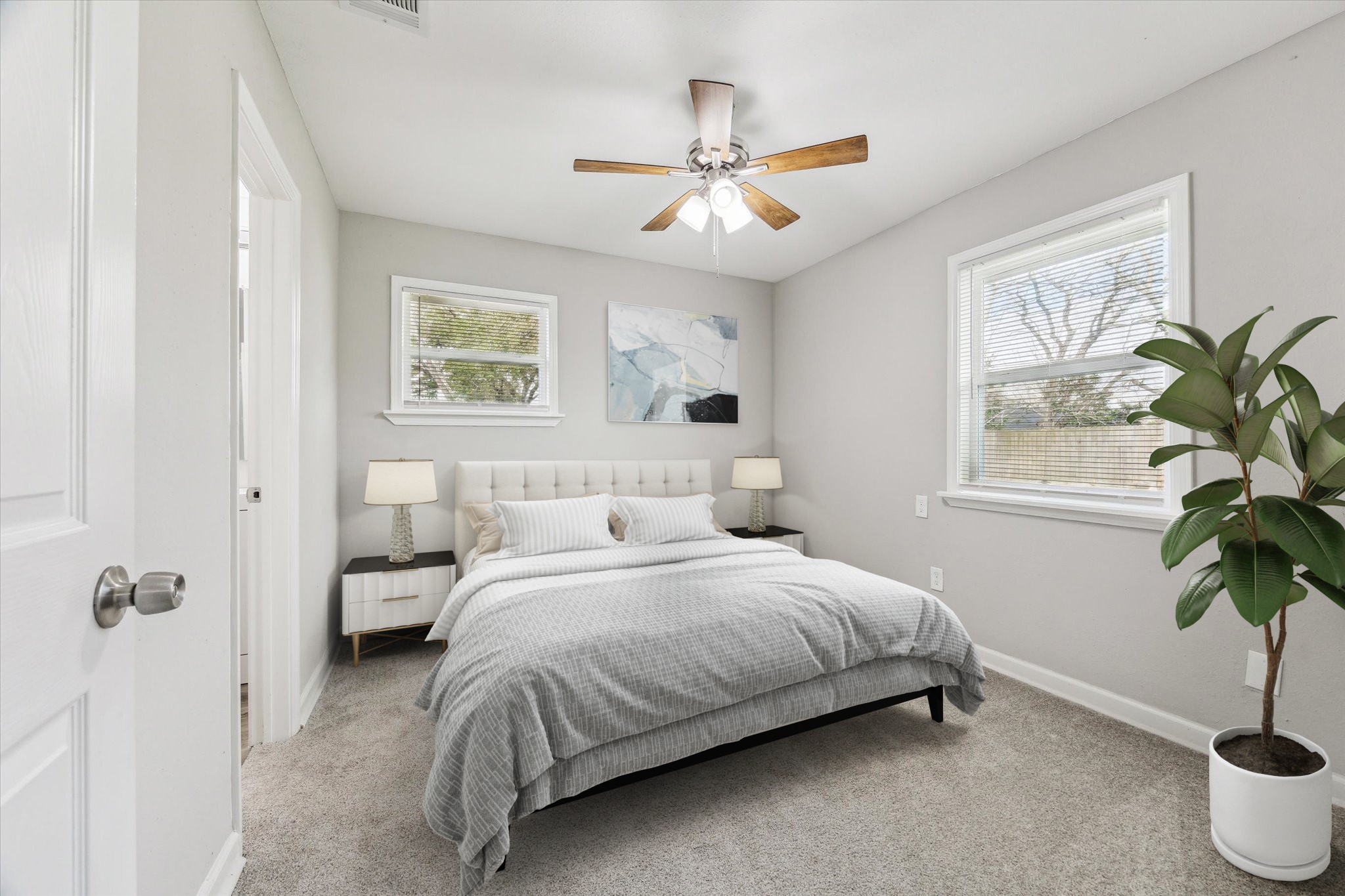 5130 Ripplebrook Drive Houston, TX 77045 - Photo 9 of 19 PRIMARY BEDROOM with new vinyl plank flooring, fresh paint, windows with window blinds and new ceiling fan/light. It also has a closet and en-suite bathroom for convenience. Note: This photo has been virtually staged.