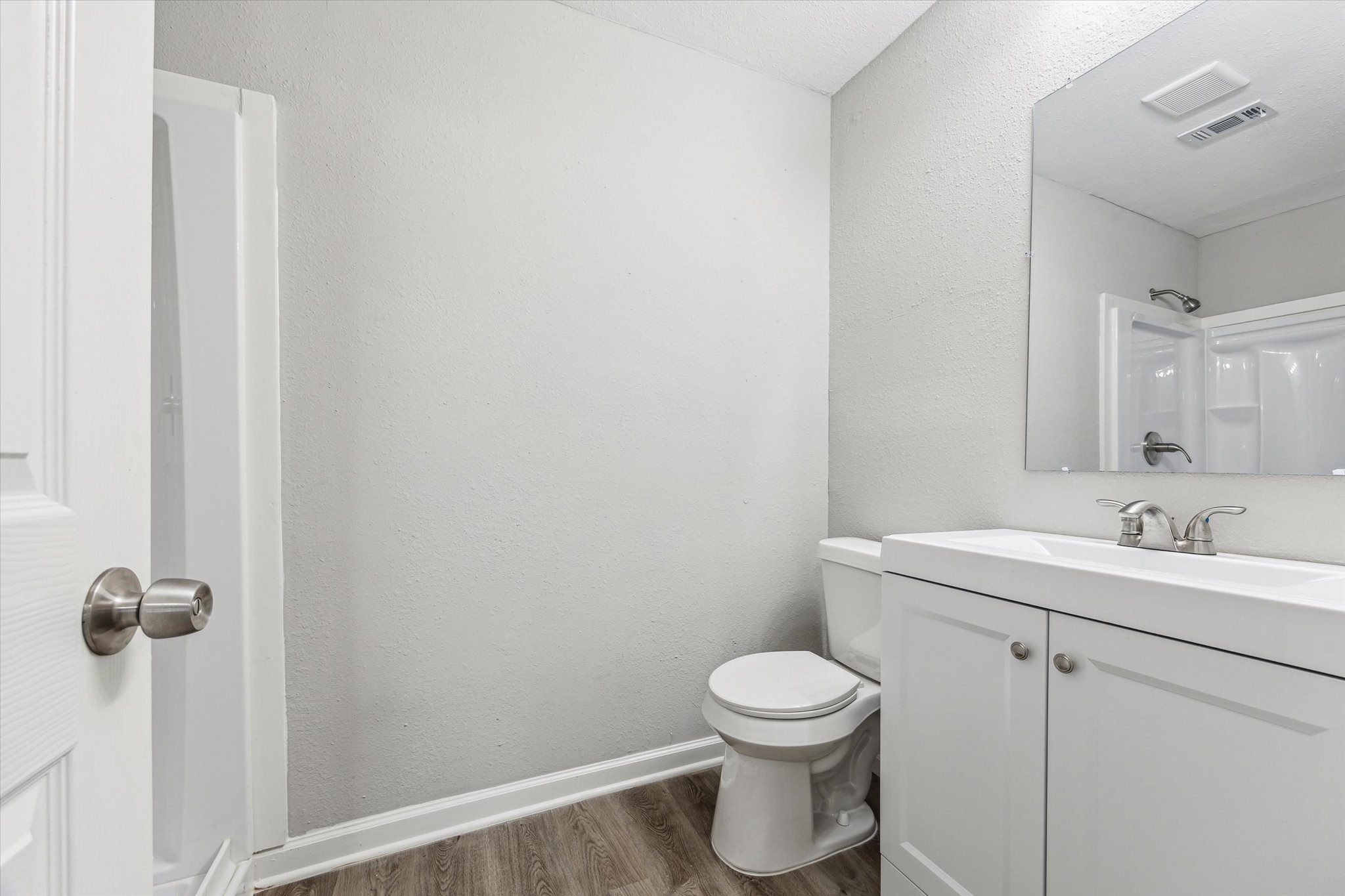 5130 Ripplebrook Drive Houston, TX 77045 - Photo 10 of 19 Ensuite bathroom for primary bedroom features new vanity with storage, new toilet and new shower!