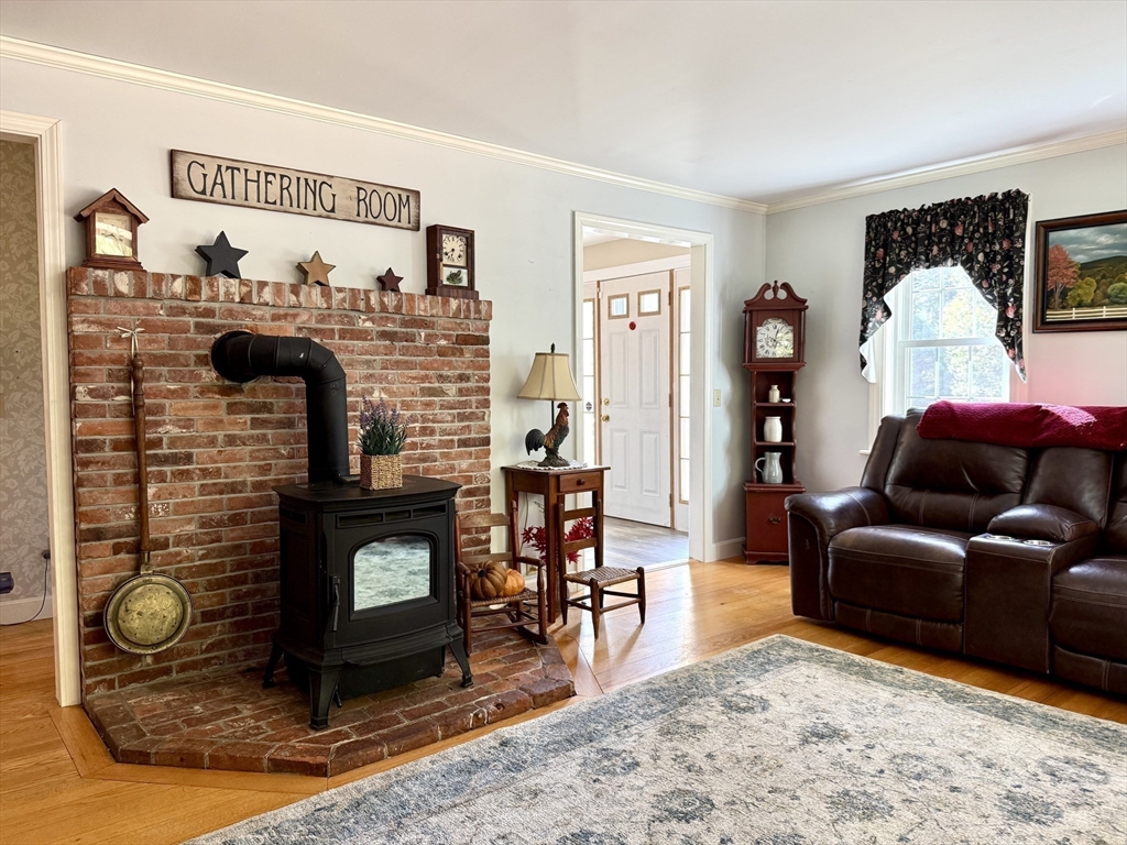 41 Hog Hollow Road Buckland, MA 01370 - Photo 11 of 42 a living room with furniture a flat screen tv and a fireplace