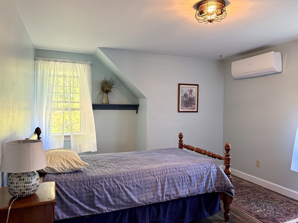41 Hog Hollow Road Buckland, MA 01370 - Photo 27 of 42 a bedroom with a bed and a chandelier