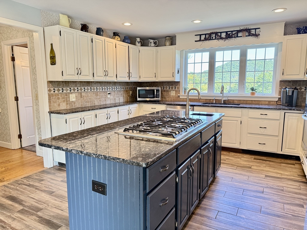 41 Hog Hollow Road Buckland, MA 01370 - Photo 5 of 42 a kitchen with stainless steel appliances granite countertop a stove and a wooden cabinets