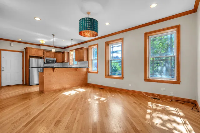 a view of a kitchen with wooden floor and a window