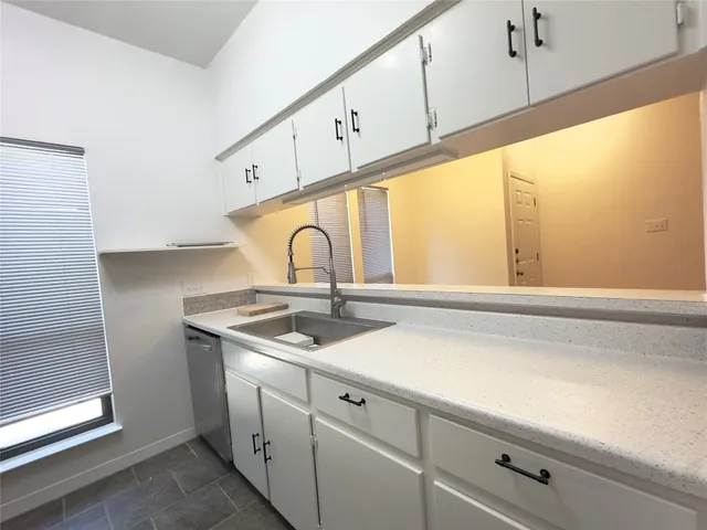 a close view of sink a faucet and appliance in the kitchen