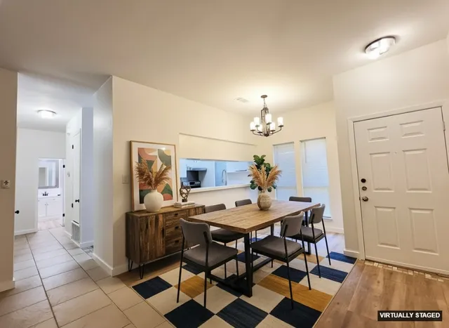 a view of a dining room with furniture and chandelier