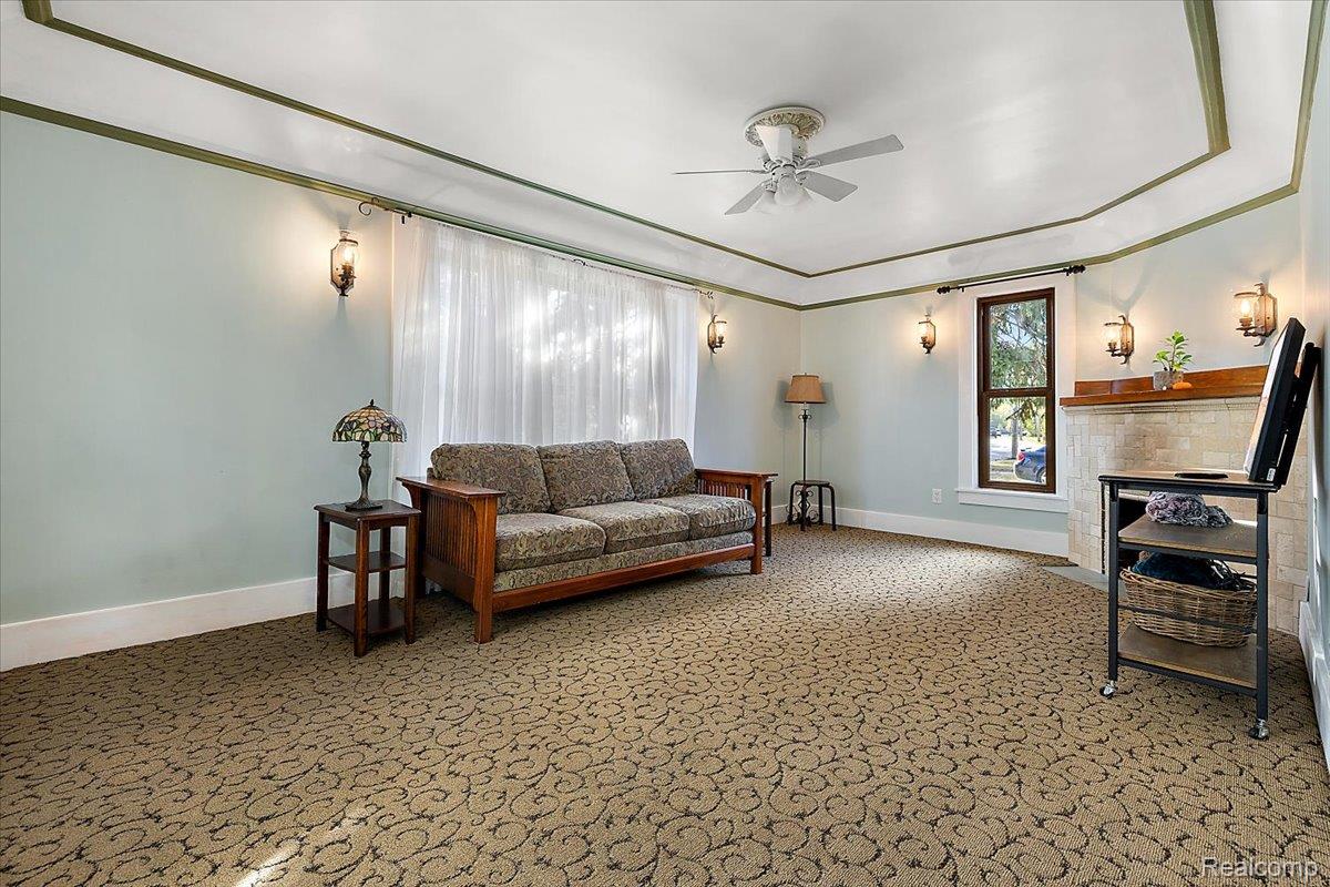 5815 Chicago Road Warren, MI 48092 - Photo 16 of 47 Living area with carpet flooring and a ceiling fan