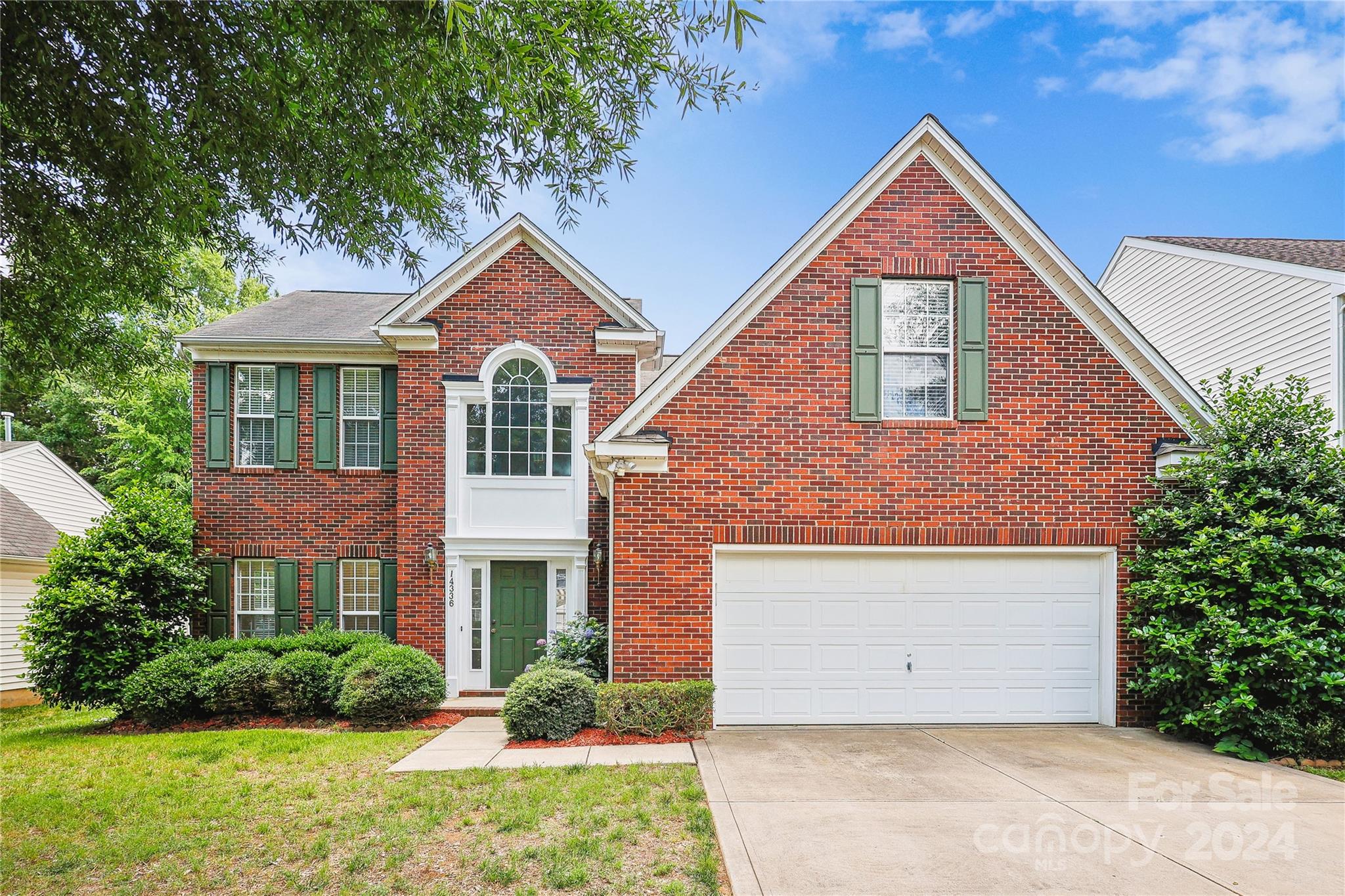 14336 Williams Glenn Road Charlotte, NC 28273 - Photo 1 of 39 a front view of a house with a yard and garage