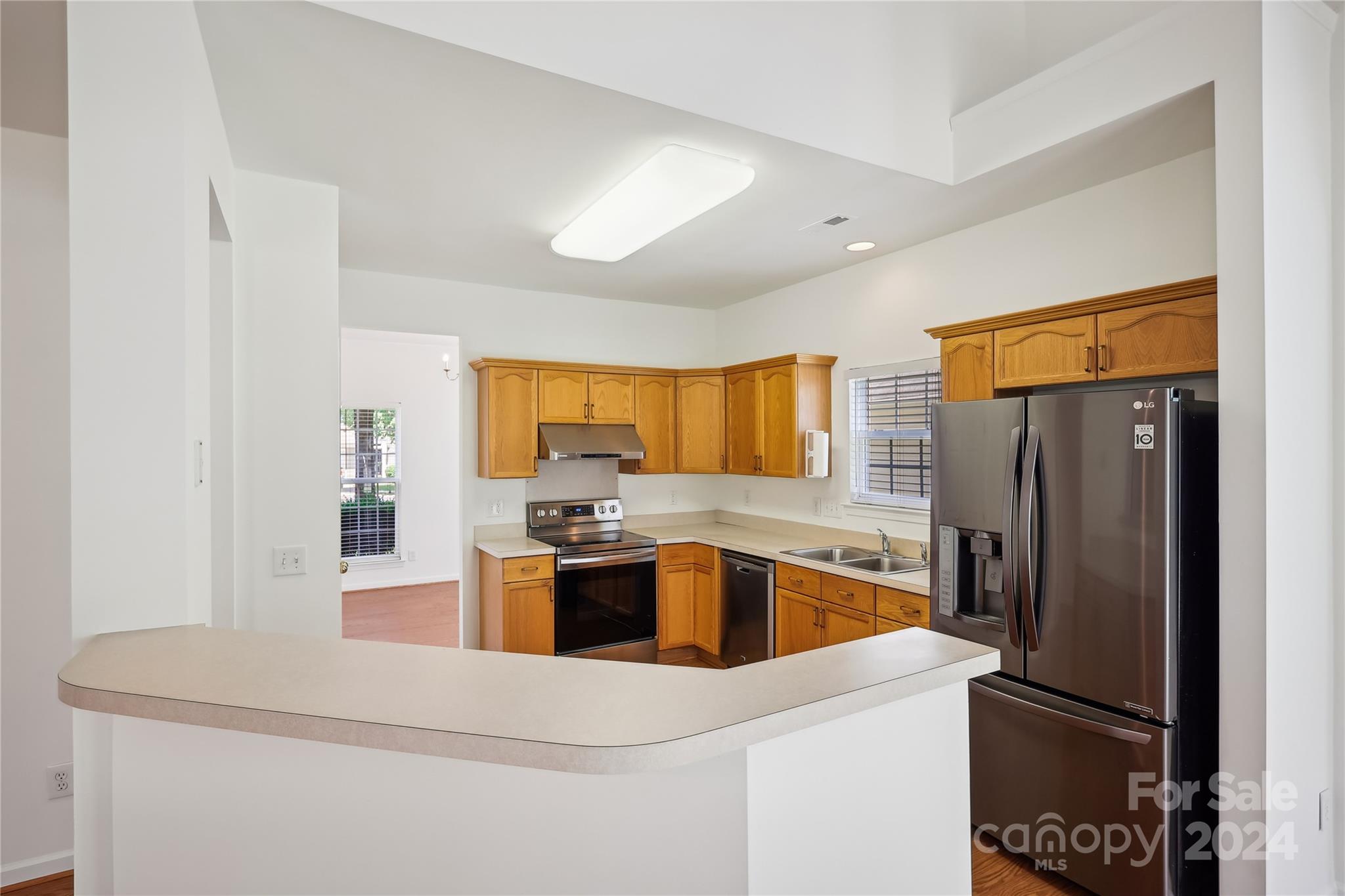 14336 Williams Glenn Road Charlotte, NC 28273 - Photo 13 of 39 a kitchen with kitchen island a refrigerator stove and sink
