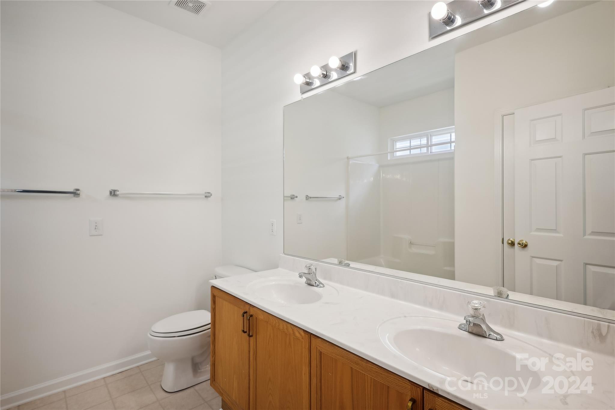 14336 Williams Glenn Road Charlotte, NC 28273 - Photo 19 of 39 a bathroom with a granite countertop sink a toilet and a mirror