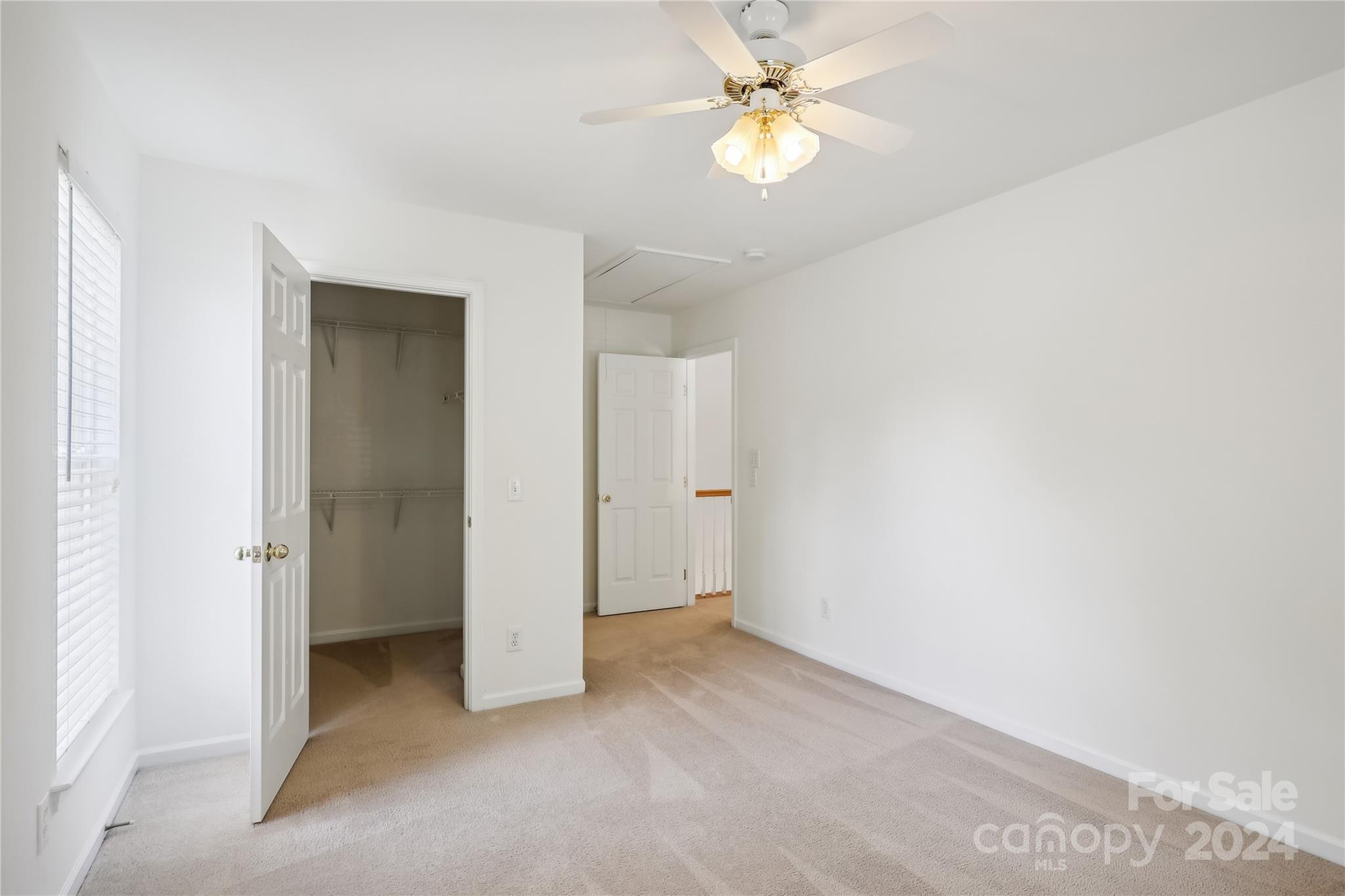 14336 Williams Glenn Road Charlotte, NC 28273 - Photo 26 of 39 an empty room with a ceiling fan and a bathroom