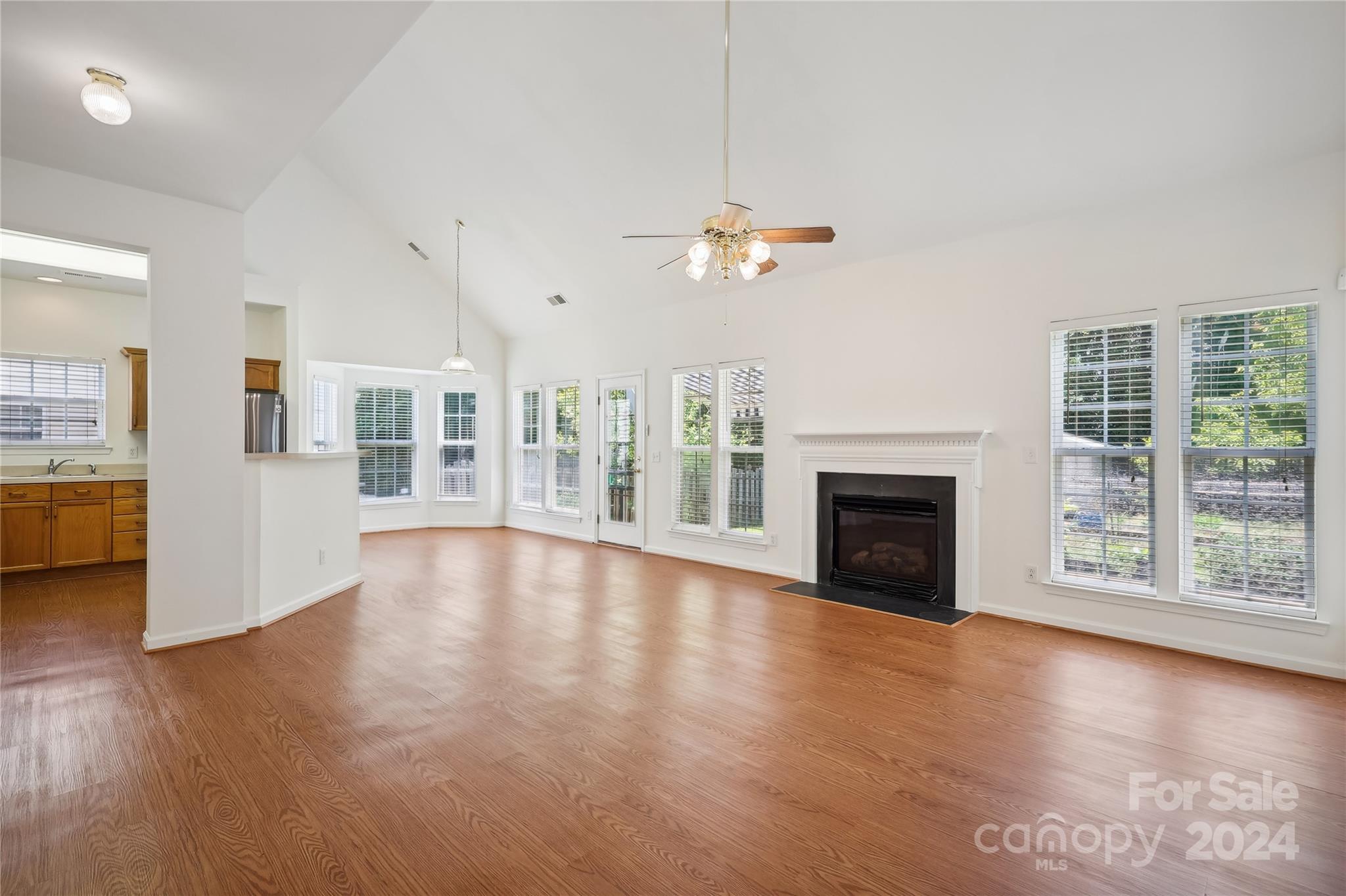 14336 Williams Glenn Road Charlotte, NC 28273 - Photo 10 of 39 a view of an empty room with wooden floor and a fireplace