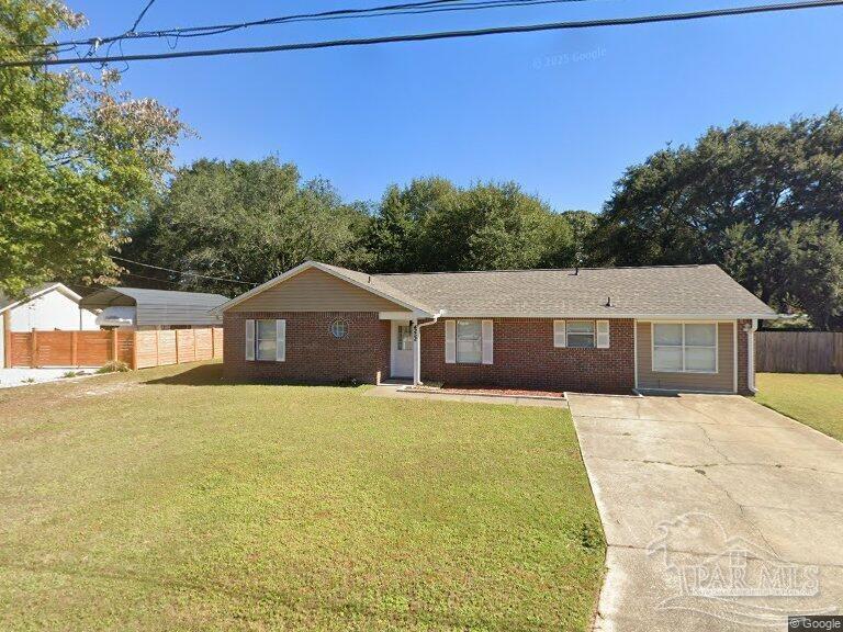 4252 Castille Avenue Milton, FL 32571 - Photo 1 of 1 a front view of a house with a yard