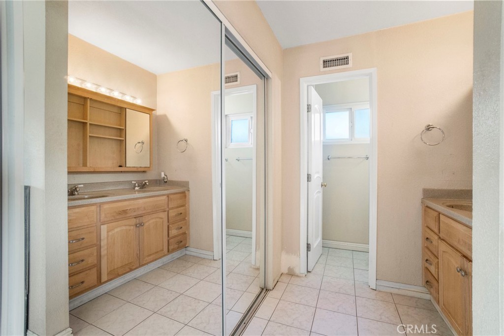 2390 Workman Avenue Simi Valley, CA 93063 - Photo 13 of 21 a bathroom with a granite countertop sink and washing machine