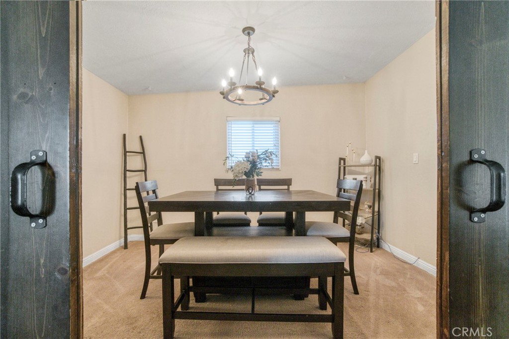 2390 Workman Avenue Simi Valley, CA 93063 - Photo 6 of 21 a view of a dining room with furniture a chandelier and wooden floor