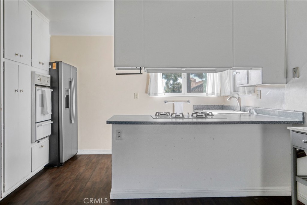 2390 Workman Avenue Simi Valley, CA 93063 - Photo 10 of 21 a kitchen with granite countertop a refrigerator a sink and wooden floors