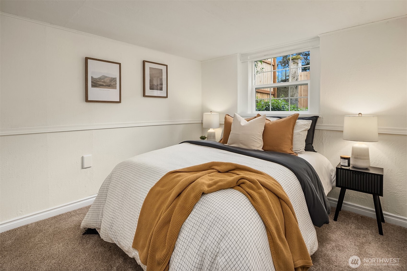 5519 18th Avenue South Seattle, WA 98108 - Photo 23 of 32 a bedroom with a bed and painting on the wall