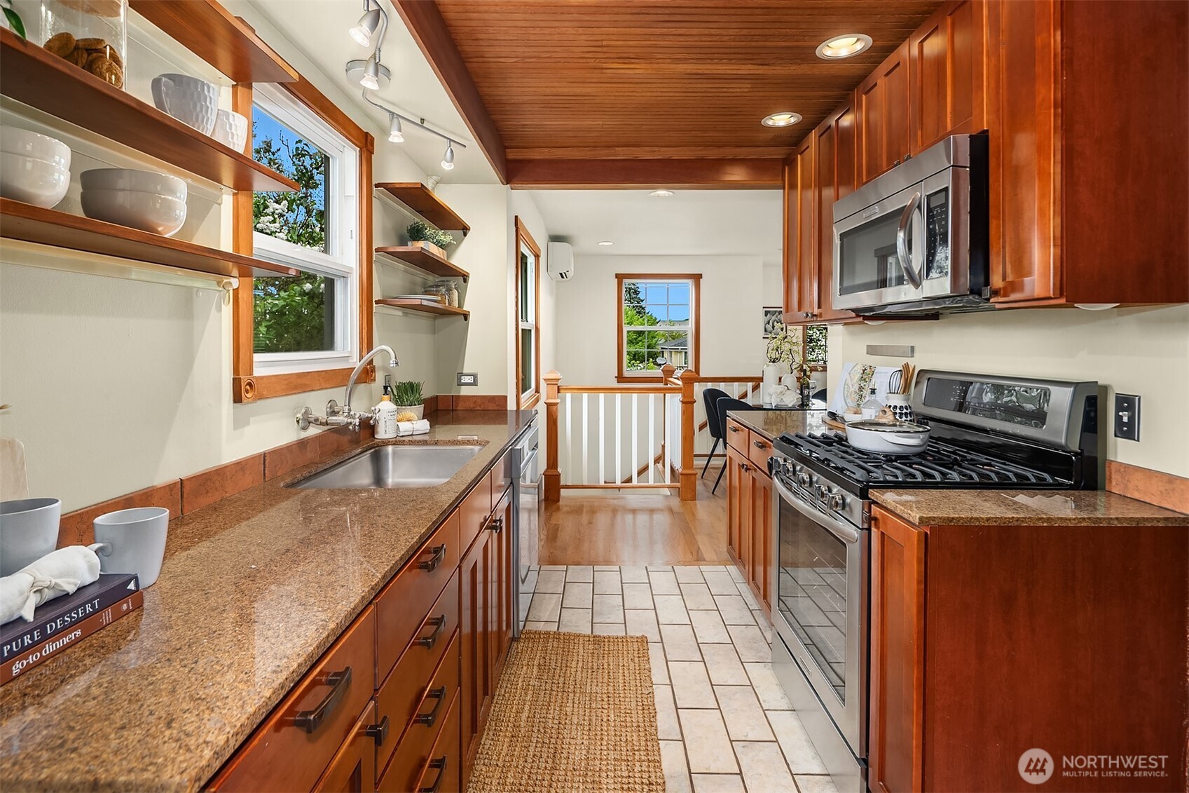 5519 18th Avenue South Seattle, WA 98108 - Photo 9 of 32 a kitchen with stainless steel appliances granite countertop a stove a sink and a microwave