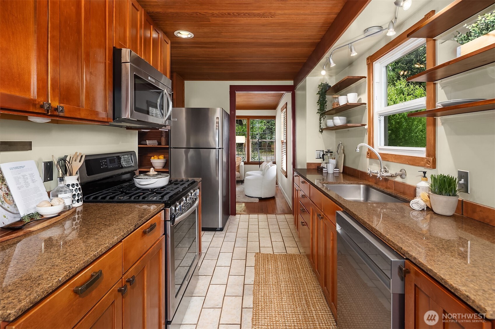 5519 18th Avenue South Seattle, WA 98108 - Photo 10 of 32 a kitchen with stainless steel appliances granite countertop a sink a stove and a wooden cabinets