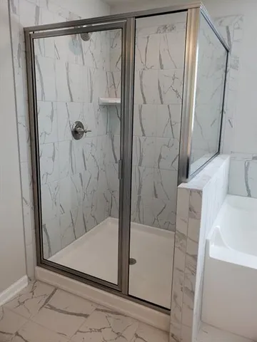 a bathroom with a bathtub and shower