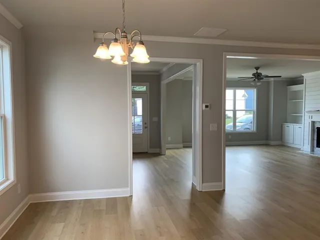 a view of livingroom with chandelier and wooden floor