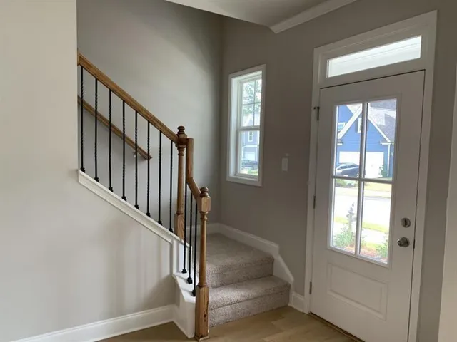a view of staircase with white walls and windows
