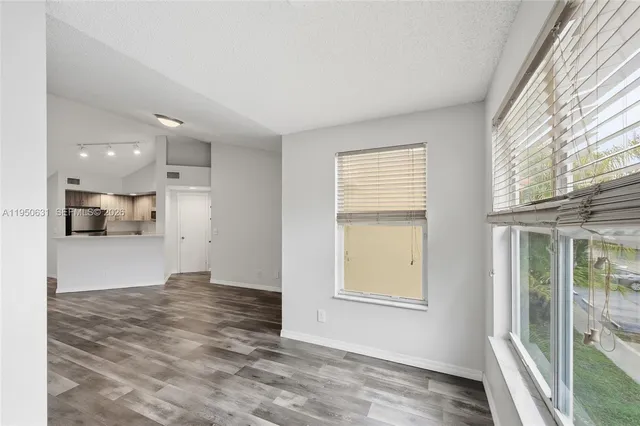 a front view of a house with a yard and potted plants