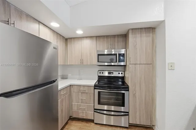 an aerial view of a house with a yard and a lake view