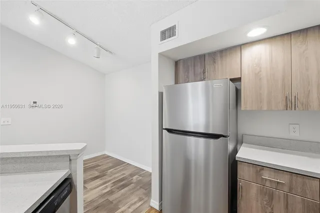 an aerial view of a house with a yard and lake view