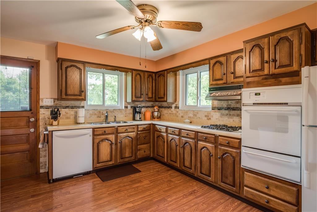 249 Barbara Drive McKees Rocks, PA 15136 - Photo 9 of 20 The spacious eat in kitchen has raised wood cabinets, a drop in cook top gas stove, double oven, a lot of windows, light and room for a table.