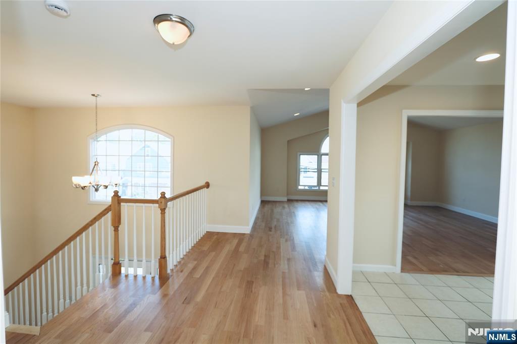 23 Main Avenue Wallington, NJ 07057 - Photo 4 of 29 a view of a hallway with wooden floor and staircase