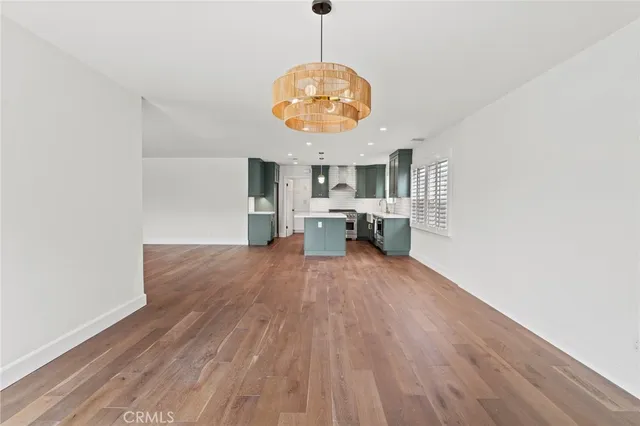 a view of kitchen and hall with wooden floor