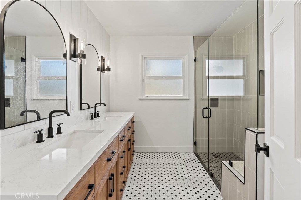23642 Community Street West Hills, CA 91304 - Photo 18 of 38 a bathroom with a double vanity sink mirror and shower