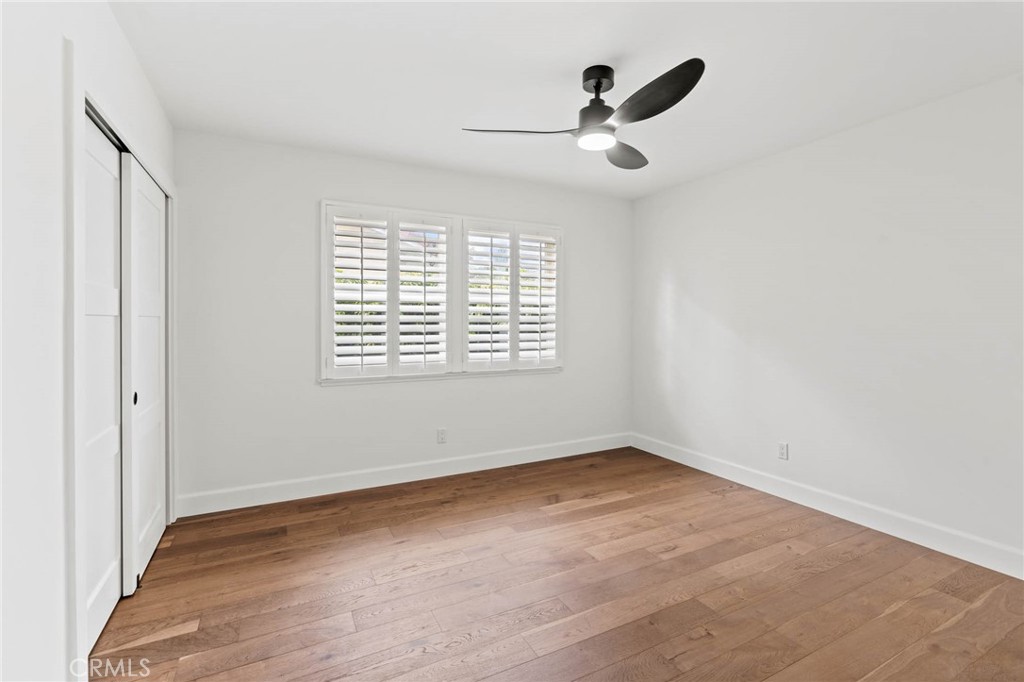 23642 Community Street West Hills, CA 91304 - Photo 22 of 38 an empty room with wooden floor fan and windows
