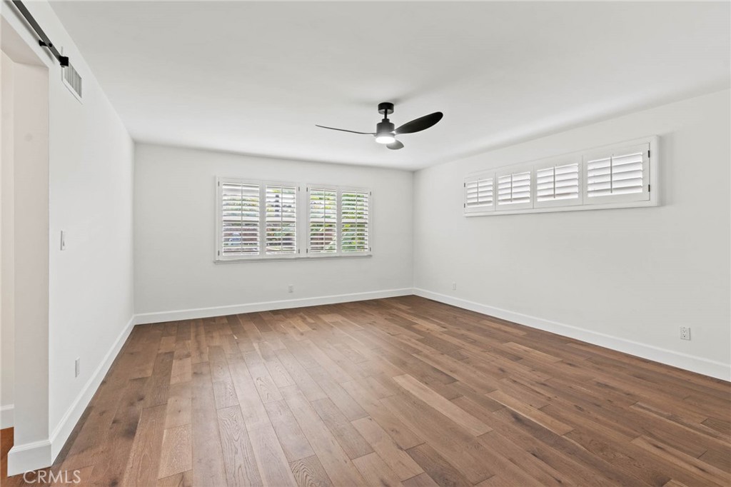 23642 Community Street West Hills, CA 91304 - Photo 23 of 38 a view of an empty room with wooden floor and a window