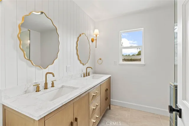 a bathroom with a double vanity sink and a mirror
