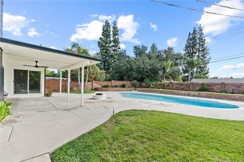 a view of a house with a backyard and a patio