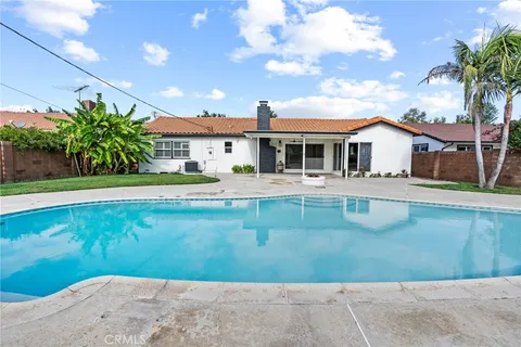 a front view of a house with swimming pool and porch