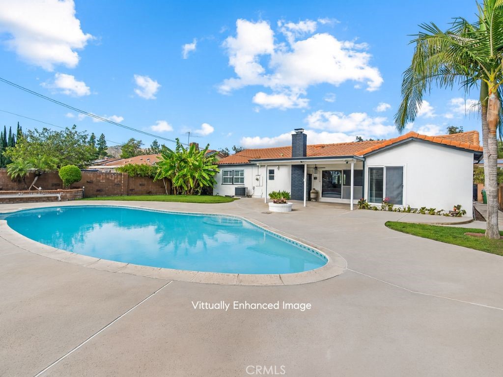 23642 Community Street West Hills, CA 91304 - Photo 35 of 38 a view of a white house with a swimming pool and a yard