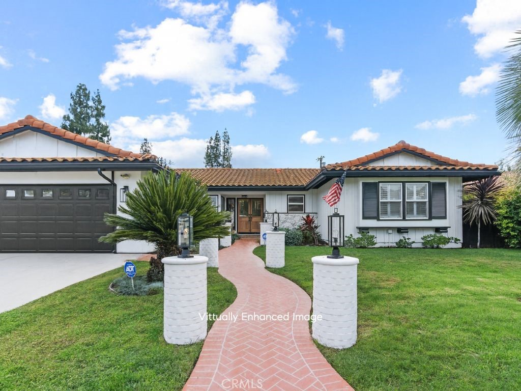 23642 Community Street West Hills, CA 91304 - Photo 4 of 38 a front view of a house with a yard table and chairs