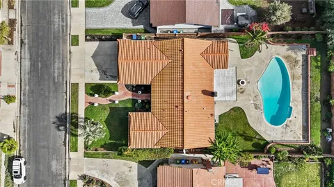 an aerial view of a residential houses with outdoor space and street view