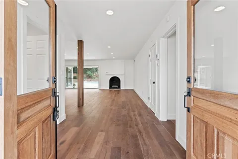 a view of a room with wooden floor and windows