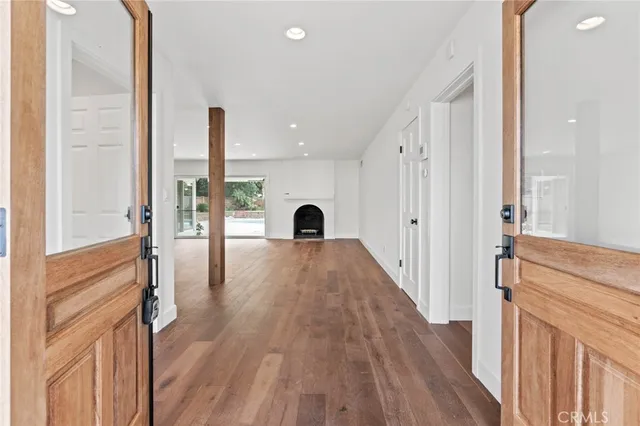 a view of a room with wooden floor and windows