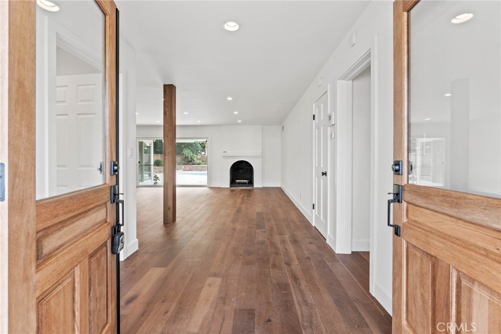 23642 Community Street West Hills, CA 91304 - Photo 7 of 38 a view of a room with wooden floor and windows